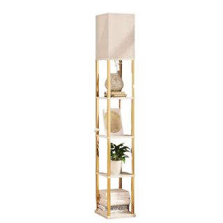 A floor lamp with four stakced shelves filled with books, plants, frames and decor