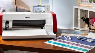 Best Brother ScanNCut machines; a white and red digital craft machine on a wooden table