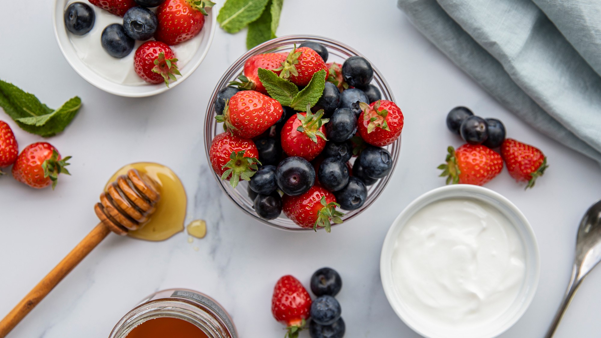 A photo of some greek yogurt, fruit and honey
