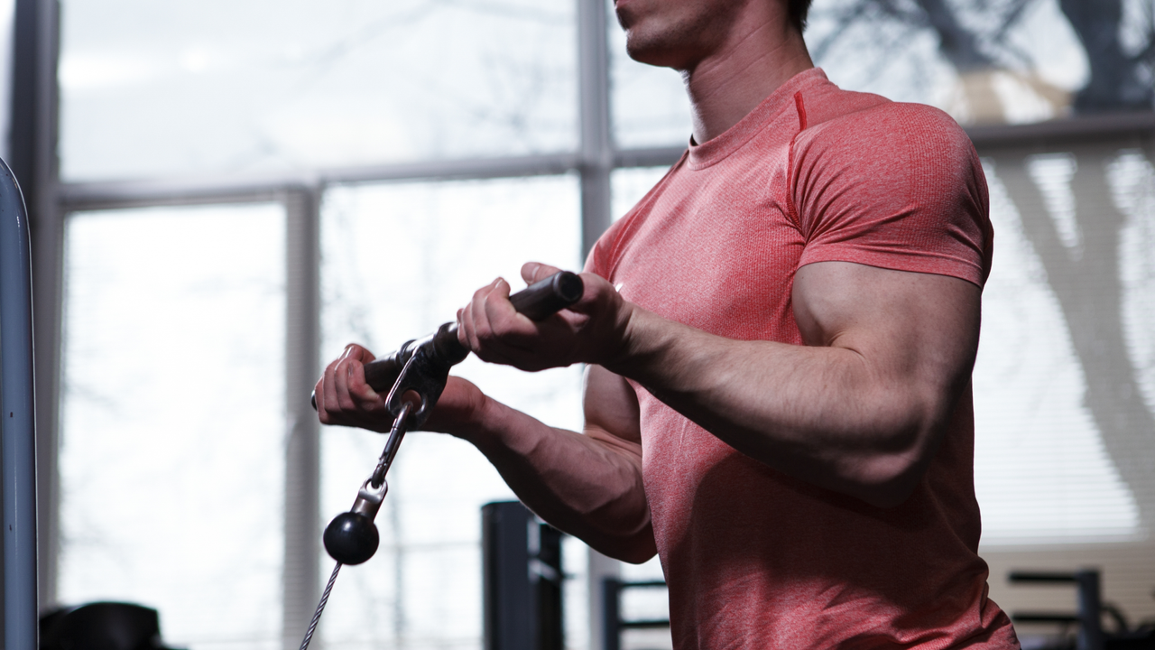 Man performing cable machine bicep curl