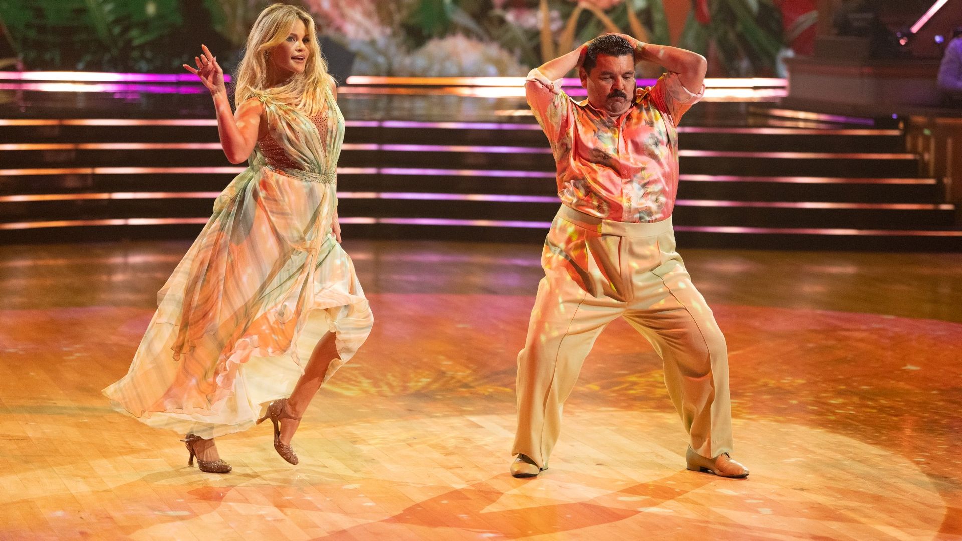 Witney and Guillermo dance on Week 4 of Dancing With The Stars. Guillermo is gyrating in a pink shirt.