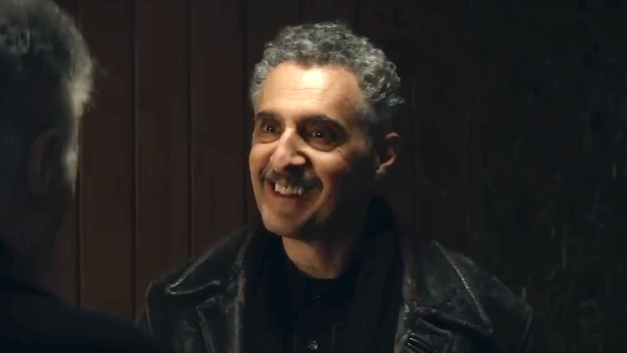 Irving with a big smile on his face talking to Bert outside Bert's front door in Severance Season 2