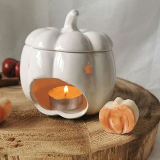 Etsy was melt ceramic holder in the shape of a pumpkin with candle in