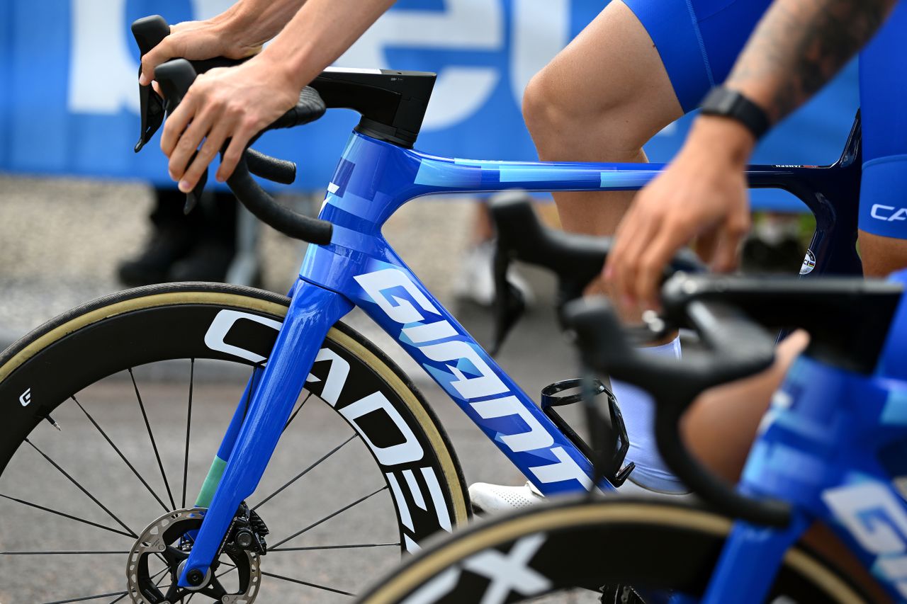 Blue Giant bike frame with a rider&#039;s hands on the hoods