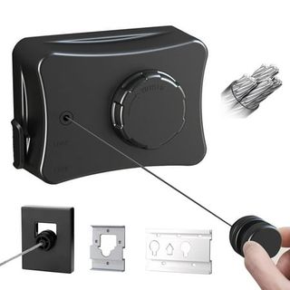 A black box with a retractable washing line inside being extended by someone's hand. 