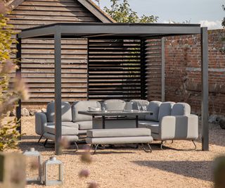 Dubrovnik Black Outdoor Aluminium Pergola with grey corner sofa underneat