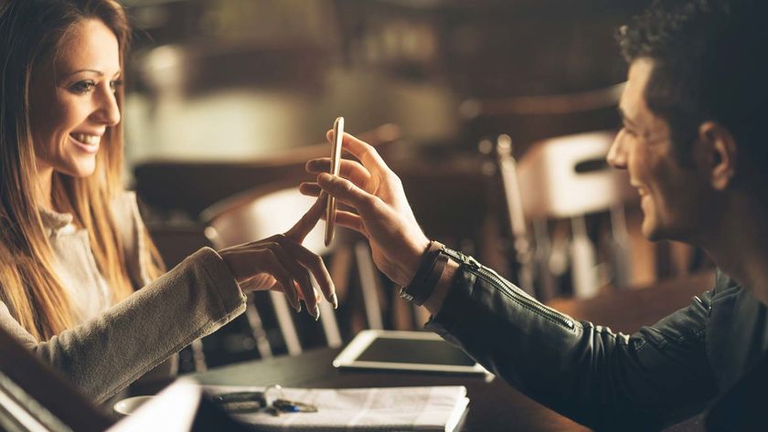 A man and a woman on a date looking at a phone