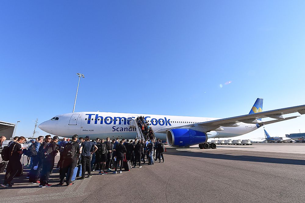 Teams line up to get on the charter plane that will take them to Italy.