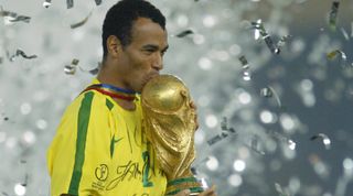 Brazil captain Cafu kisses the World Cup trophy, June 2002