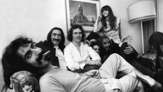 Frank Zappa and the Mothers invention sprawling on a sofa