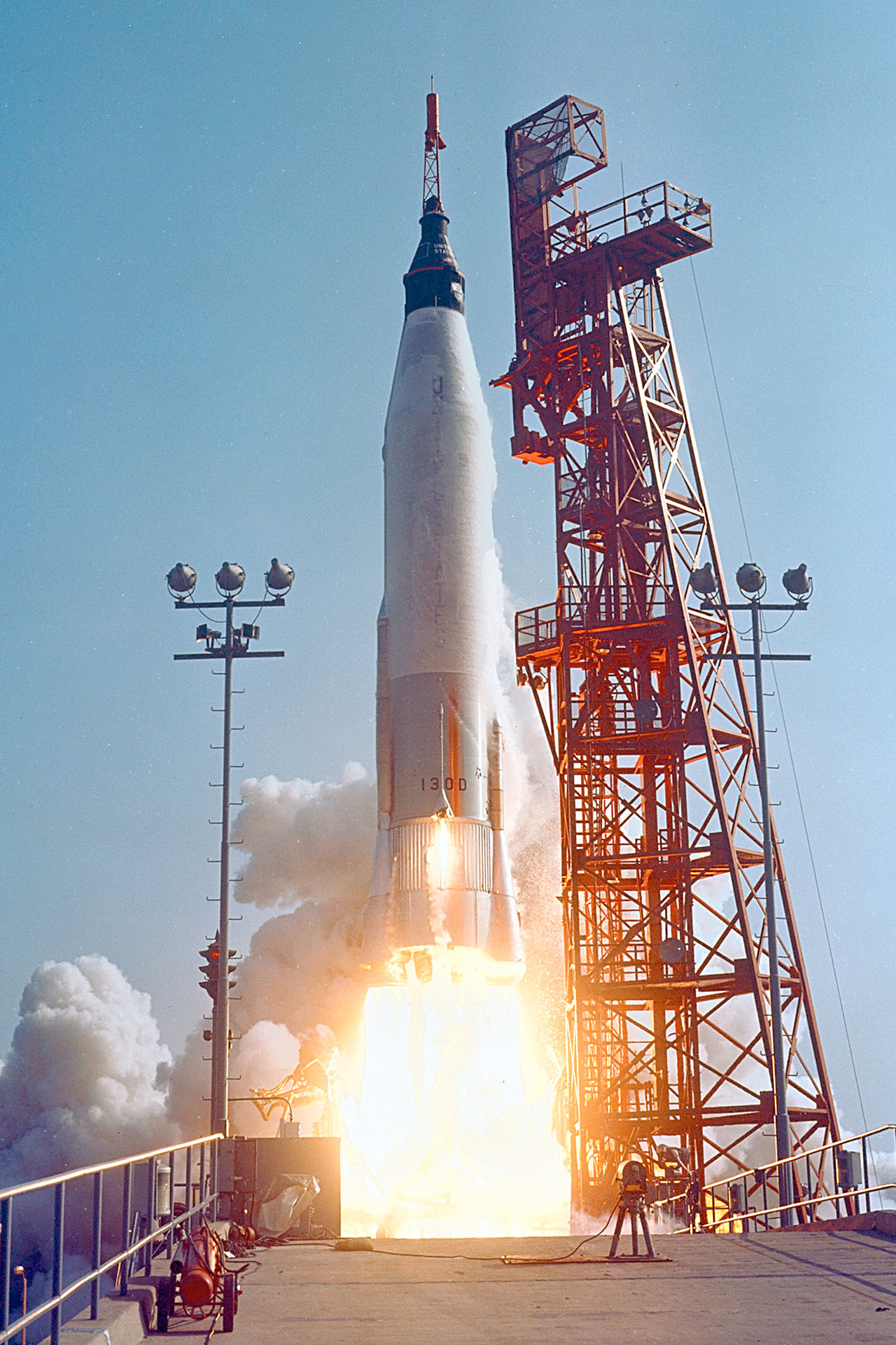 close-up photo of a white rocket launching into a blue sky