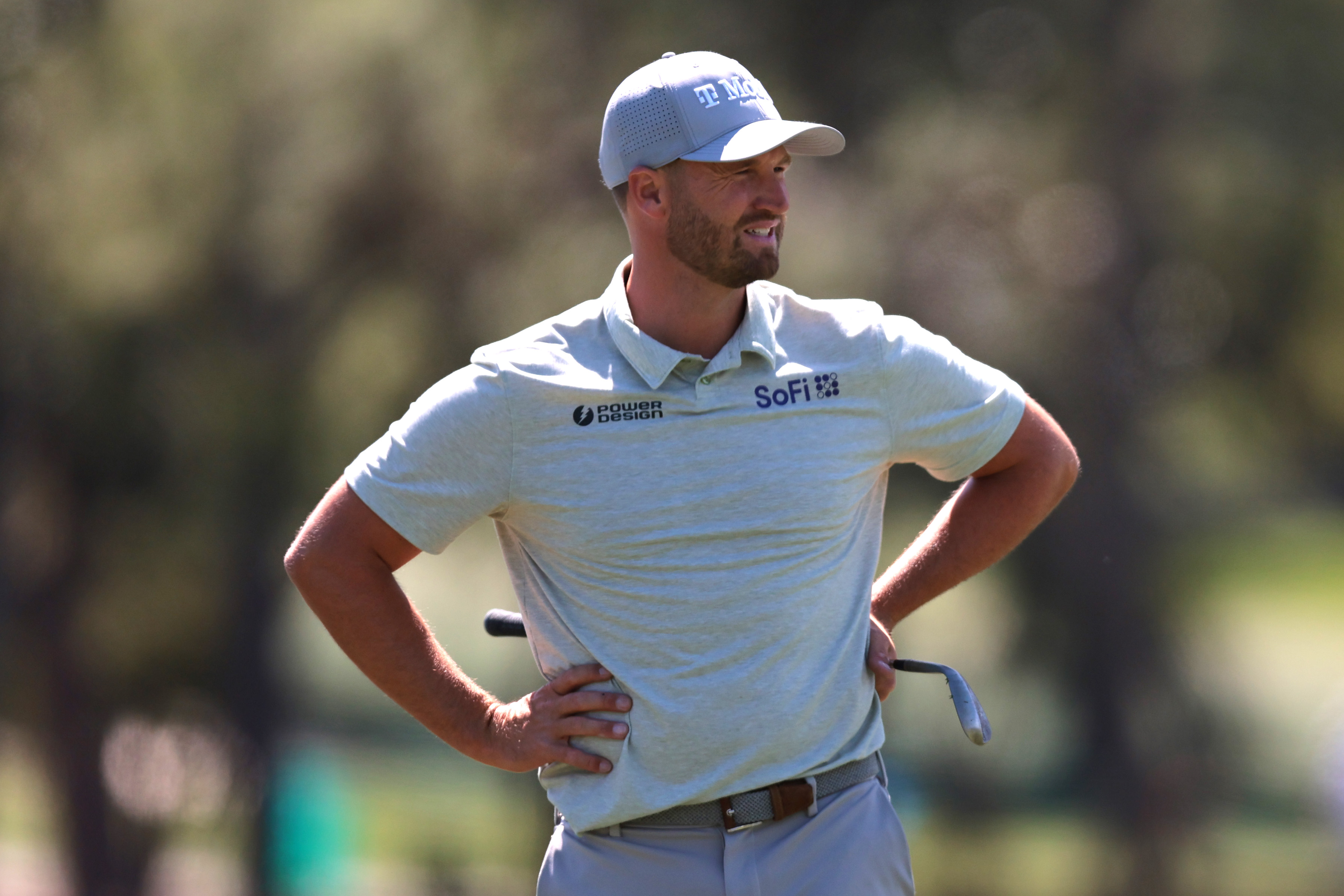 Wyndham Clark looks on with his hands on his hips