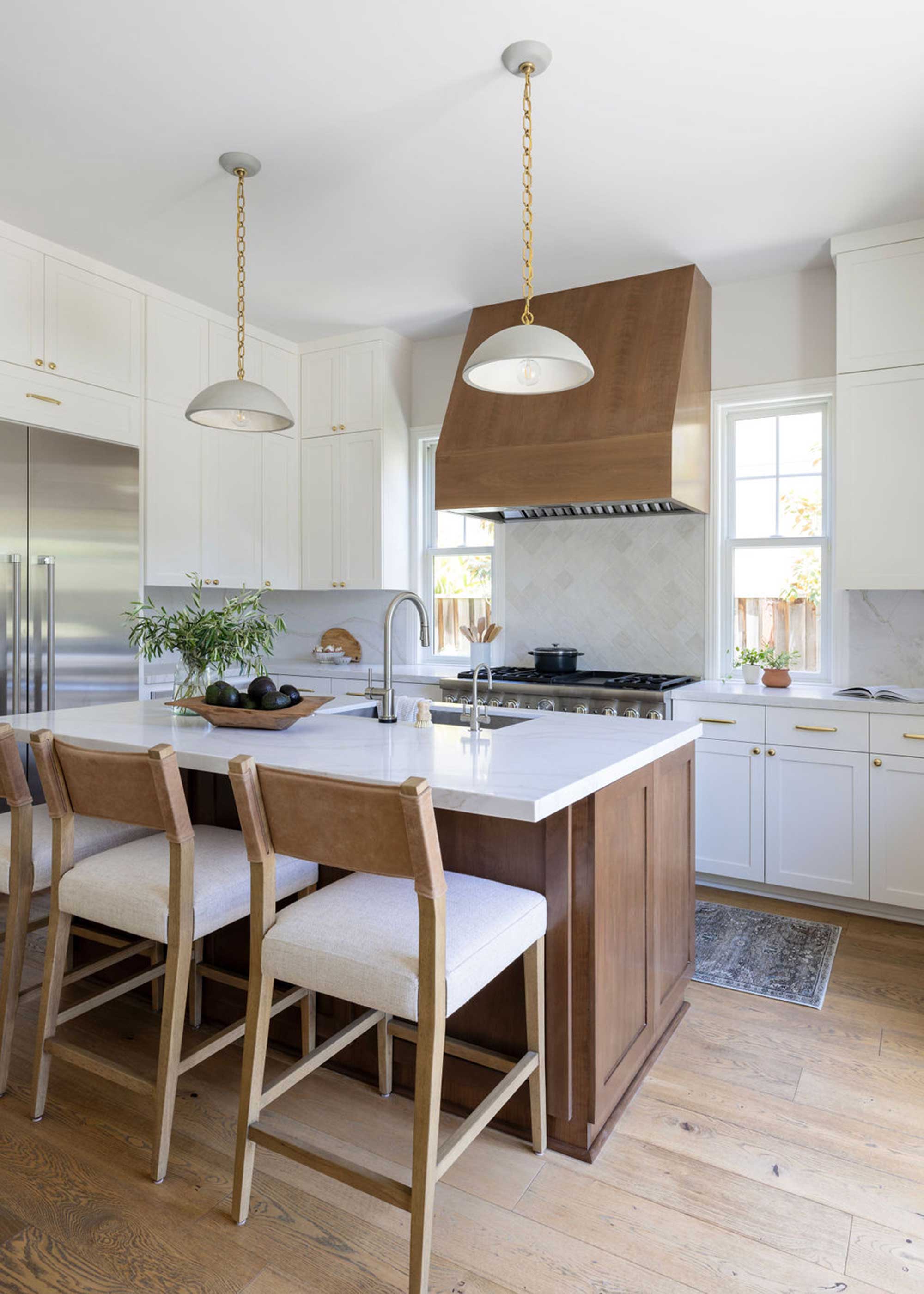 white kitchen with wooden kitchen island and wooden flooring