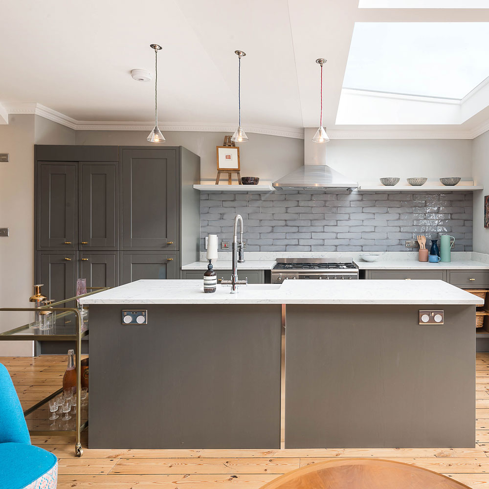 white kitchen with grey cupboard and wooden flooring