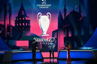 UEFA Champions League Final Ambassador for 2023 Former Turkish player Hamit Altintop (C) holds the Champions League trophy on stage in Istanbul on August 25, 2022.