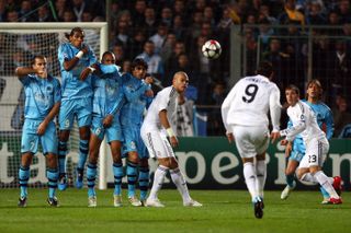 Cristiano Ronaldo scores a free-kick for Real Madrid against Marseille in 2009.