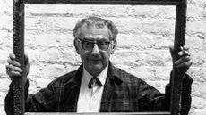 Man Ray peers through a picture frame