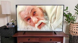 Samsung Q60D QLED TV on console in living room