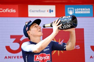 BURGOS SPAIN AUGUST 15 Jasper Philipsen of Belgium and Team AlpecinFenix celebrates winning the stage on the podium ceremony after the 76th Tour of Spain 2021 Stage 2 a 1667km stage from Caleruega Monasterio de Santo Domingo de Guzmn to Burgos Gamonal lavuelta LaVuelta21 CapitalMundialdelCiclismo on August 15 2021 in Burgos Spain Photo by Stuart FranklinGetty Images