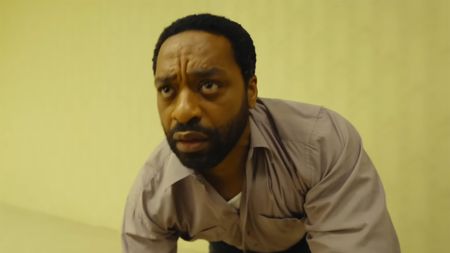 Chiwetel Ejiofer looks confused when he enters the backrooms in the new A24 movie. Everything is yellow in the background.