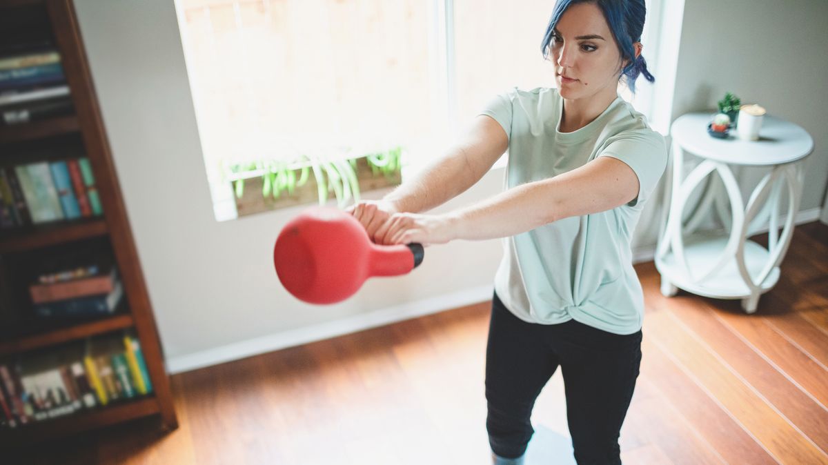 Woman performs kettlebell swing