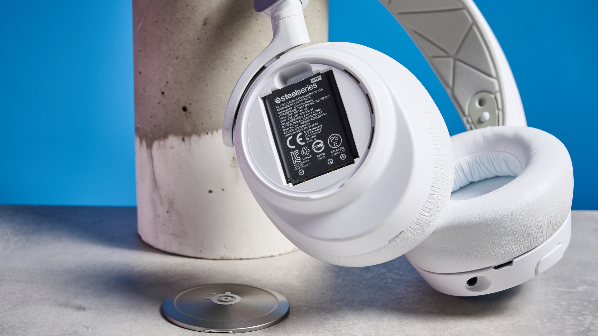 SteelSeries Arctis Nova Pro Wireless in white on a stone surface 