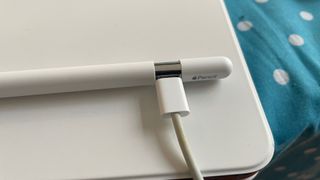 Apple Pencil USB-C charging with a wire on a white Magic Keyboard