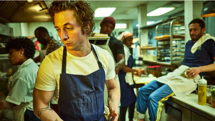 Jeremy Allen White standing in a kitchen in The Bear