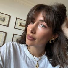 A French woman taking a selfie with glowing skin