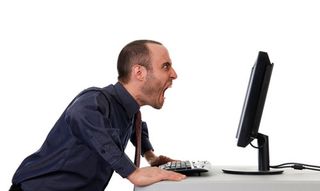 man shouting at computer monitor