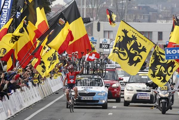 A sea of flags greets Ronde winner Fabian Cancellara, himself carrying a Swiss flag, in Ninove.