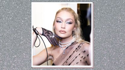 Gigi Hadid wears a black mesh dress and silver eyeshadow at The Mark Hotel before the 2023 Met Gala: Karl Lagerfeld: A Line of Beauty on May 1, 2023 in New York, New York. / In a silver glitter template