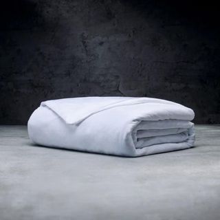 Weighted Blanket in white against a gray background.
