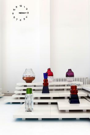 Up close image of contemporary glass designs photographed on white platforms against a white wall