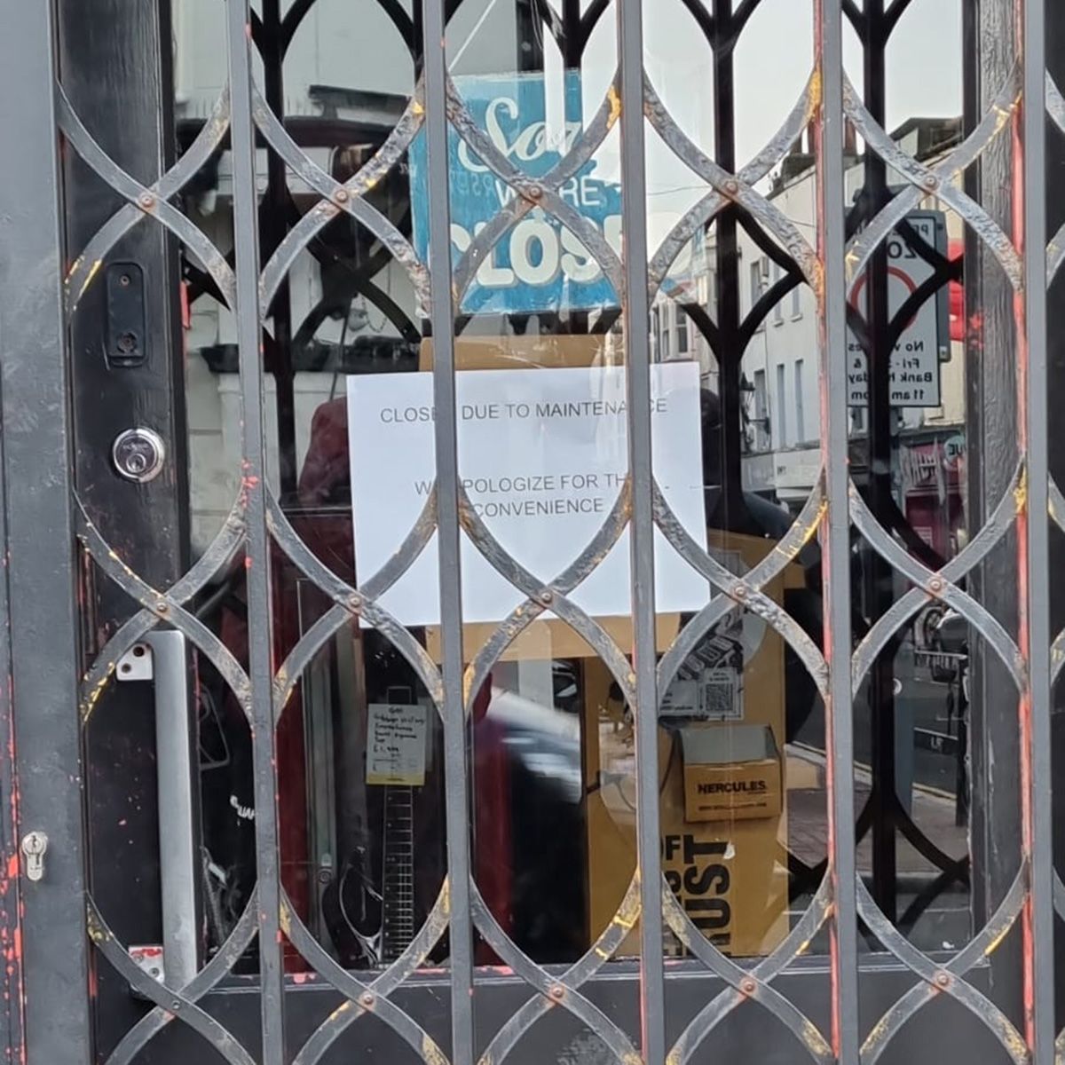 doors with shutters and "sorry we're closed" and "closed due to maintenance" signs