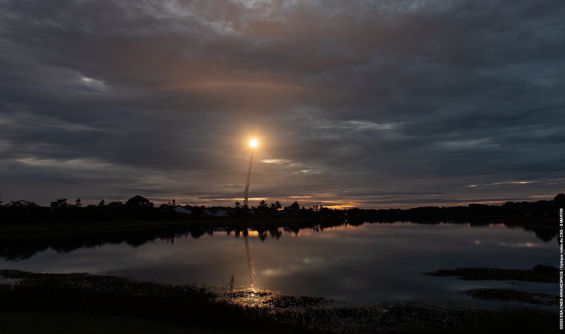 Ariane 5 VA261 brightens a cloudy sky just after sunset at Europe's Spaceport in French Guiana on 5 July 2023.