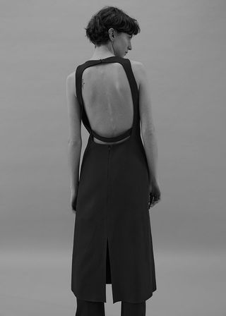 Boss backless dress worn over trousers on model