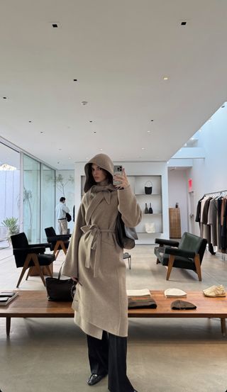 Kendall Jenner in a tan scarf coat by The Row in a picture she shared on her Instagram Story.