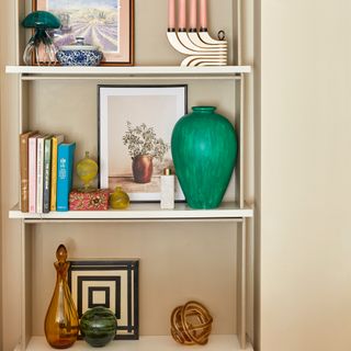 Built in shelving with books, artwork and decorative objects