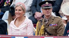 Prince Edward, wearing military uniform, and Sophie, Duchess of Edinburgh, wearing a gingham dress, sit during the military procession to mark the 80th anniversary of VE Day on May 5, 2025