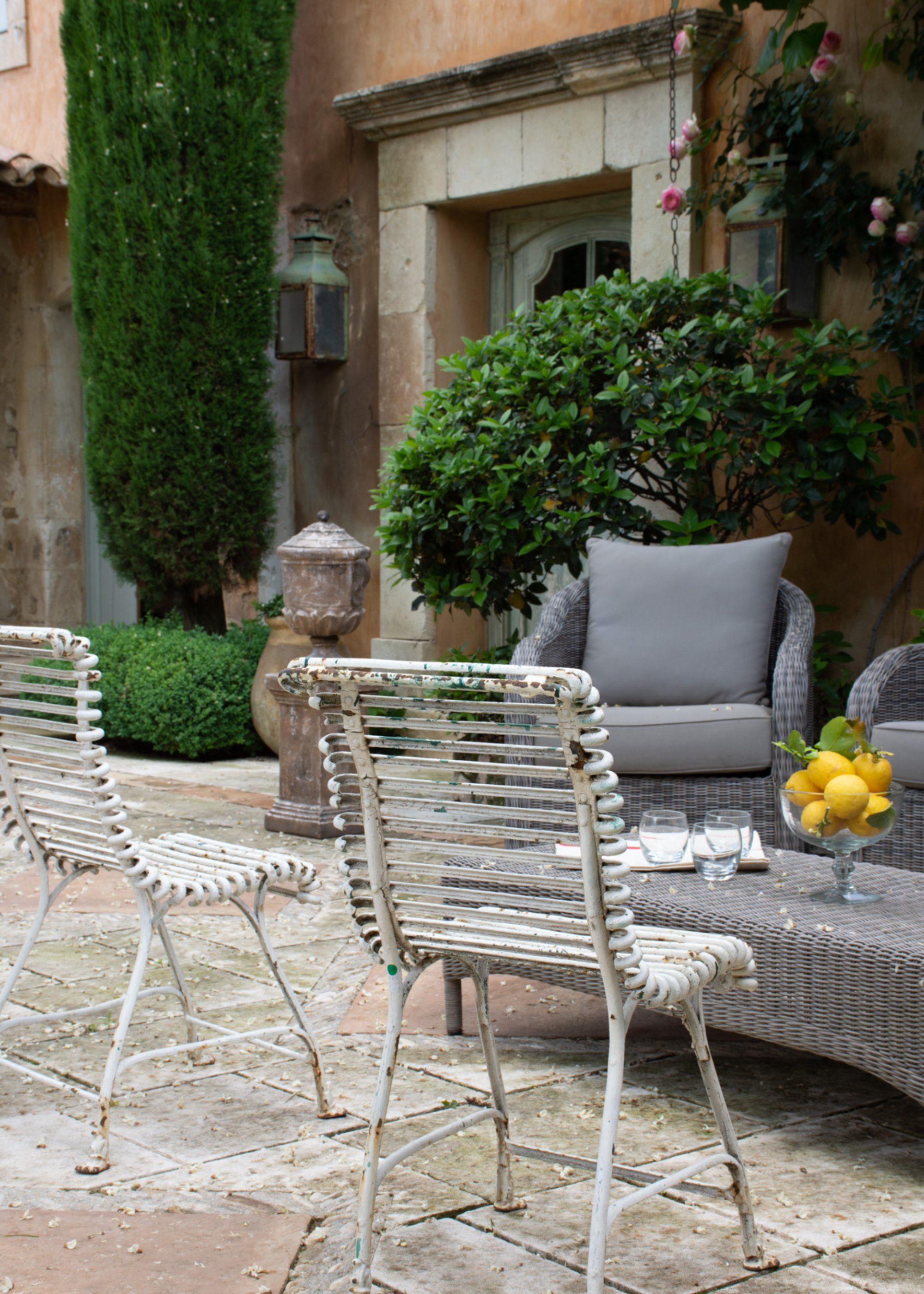 A set of iron chairs in a backyard