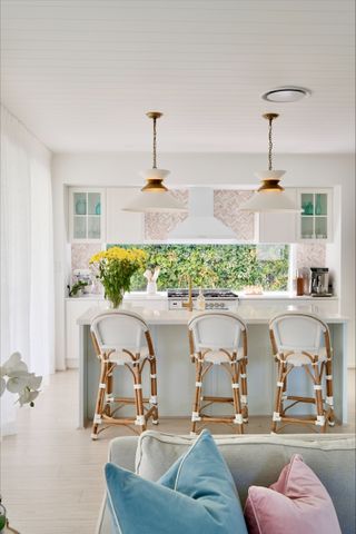 kitchen with white cabinetry and window backsplash