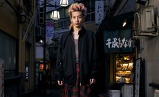 Man on Japanese street in Baracuta x Junya Watanabe Harrington jacket and kilt