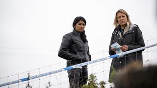 DC Harper Weston (VARADA SETHU), DI Annika Strandhed (NICOLA WALKER) standing looking at a crime scene