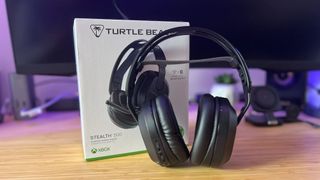 Turtle Beach Stealth 500 headset set up against packaging on a wooden desk