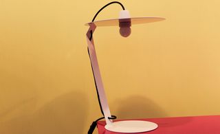 Steel table lamp on red table