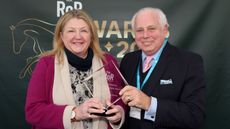 Grace Muir receives the Sir Peter O&rsquo;Sullevan RoR Community Impact award from RoR chairman David Thorpe.