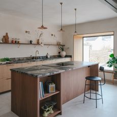 kitchen with wood island and stone tops