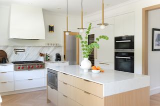 a kitchen with all-white cabinets and countertop
