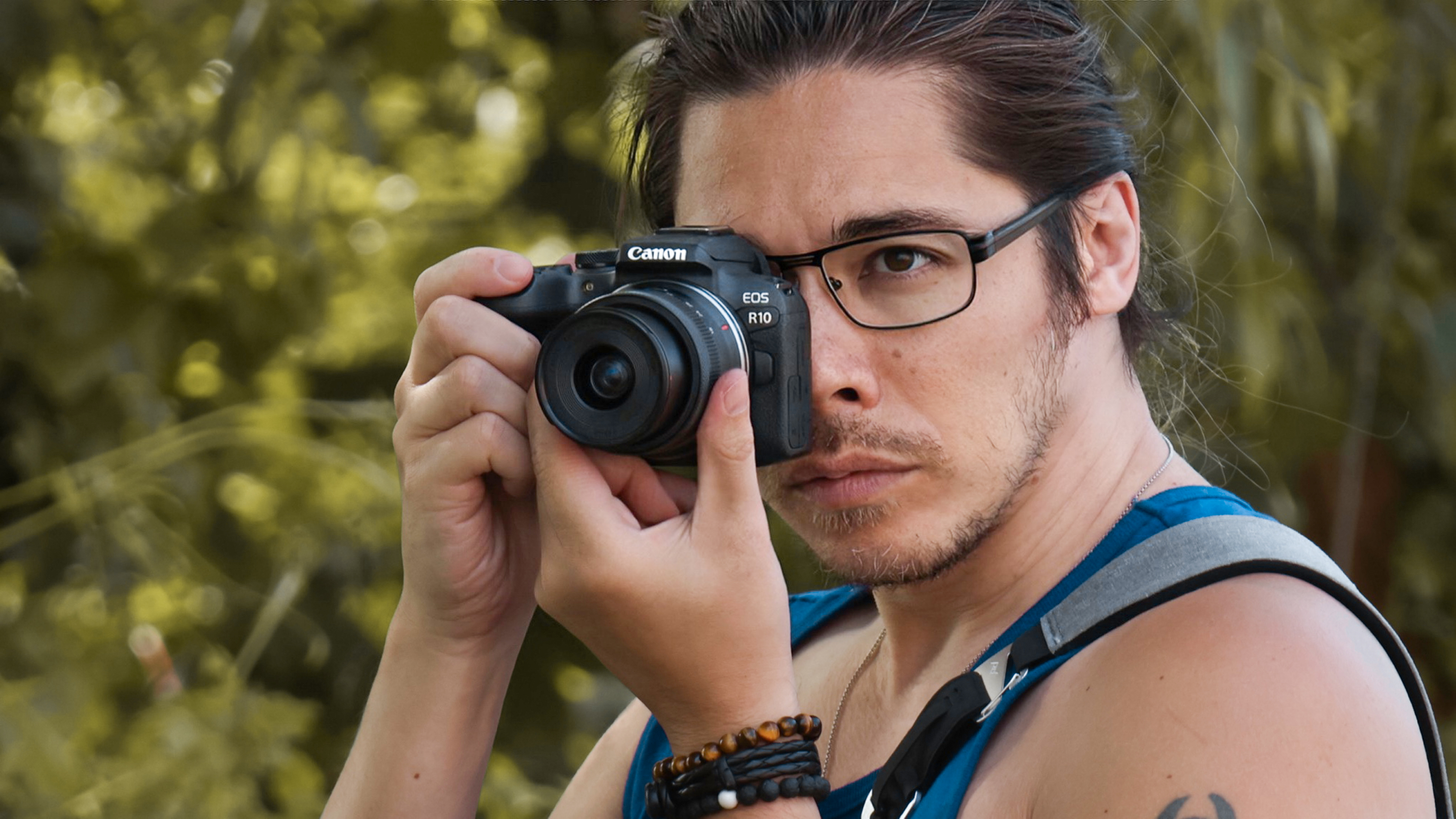 Canon EOS R10 being held by photographer James Artaius, outdoors